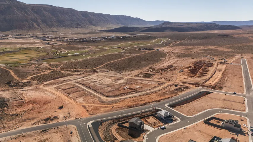 Aerial view of property and surrounding area featuring a mountain backdrop and rural landscape