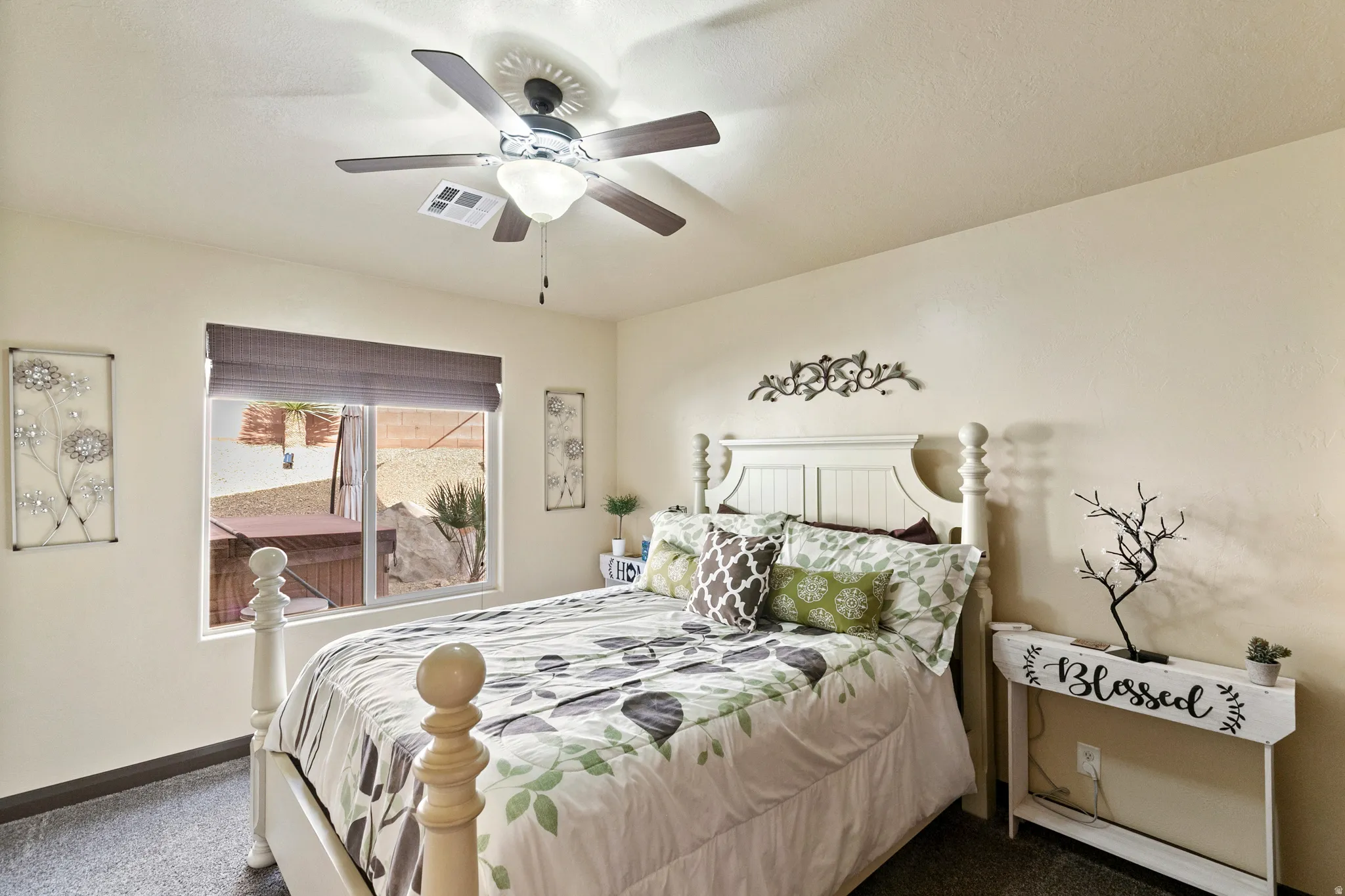 Bedroom with dark colored carpet and a ceiling fan