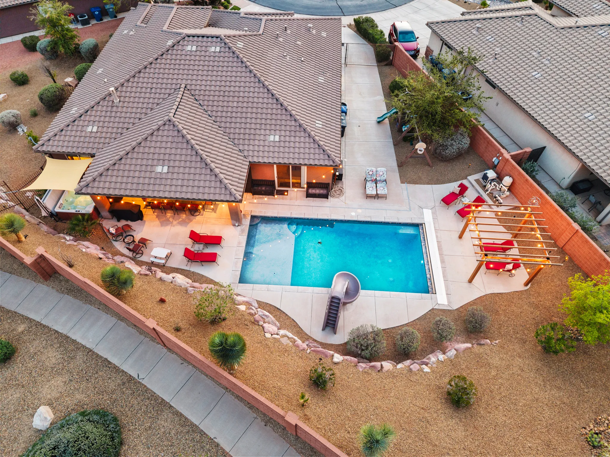 View of swimming pool with patio surround and a fenced backyard
