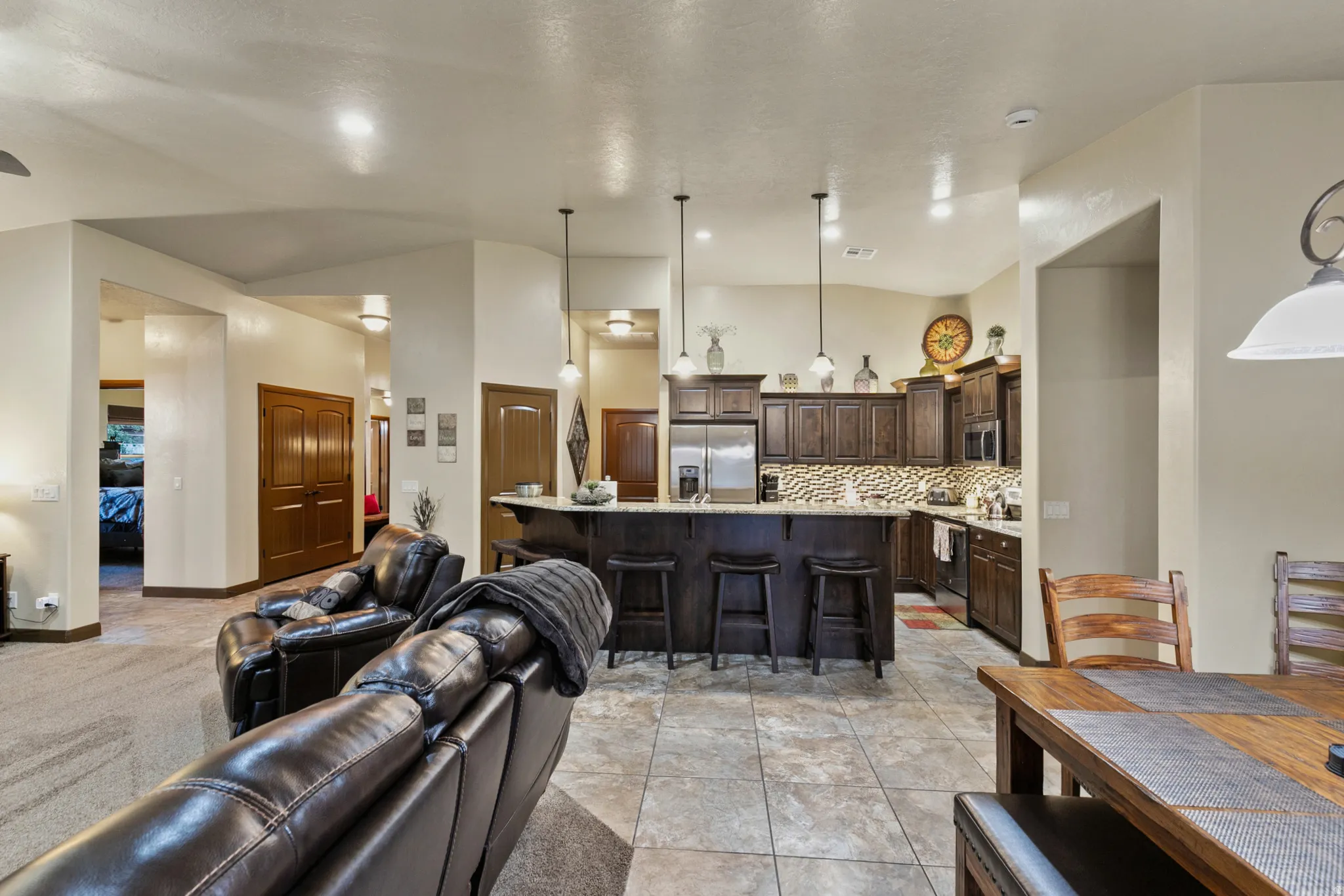 Living room featuring a high ceiling and light tile patterned flooring