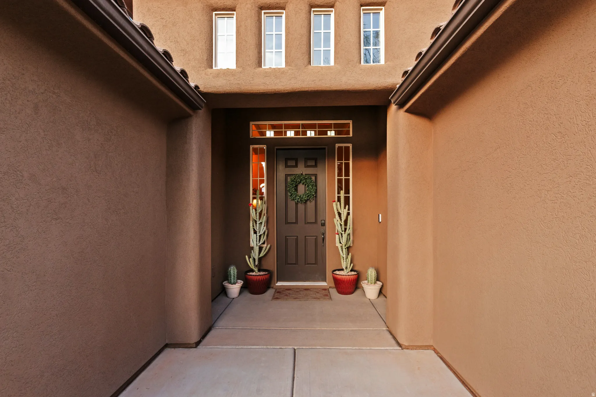 View of exterior entry with stucco siding