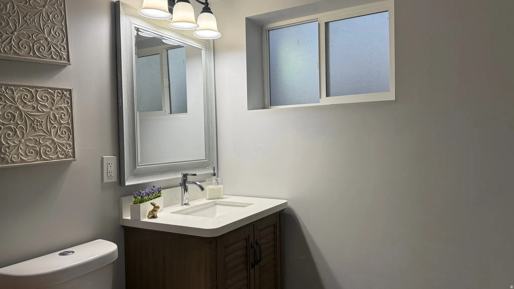 Half bath featuring vanity and toilet