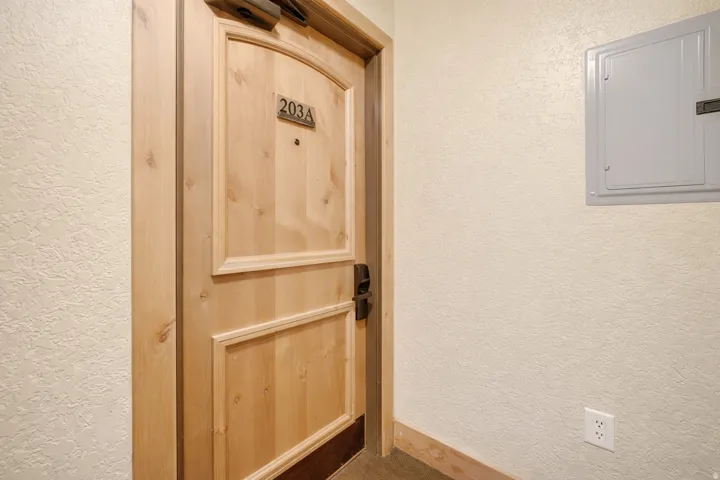 View of exterior entry with electric panel