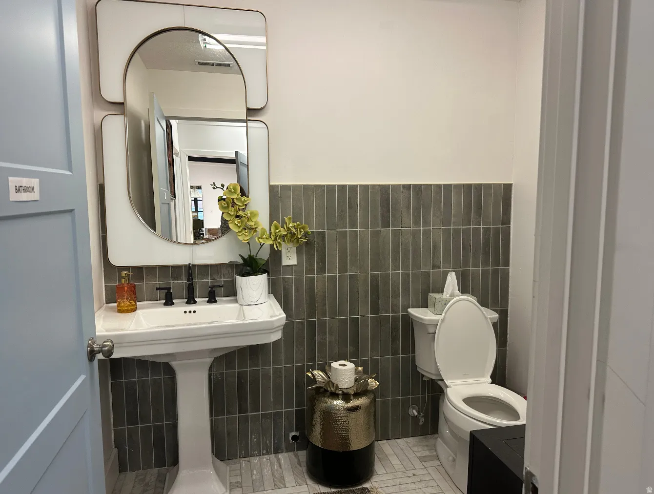 Bathroom with tile walls and wainscoting