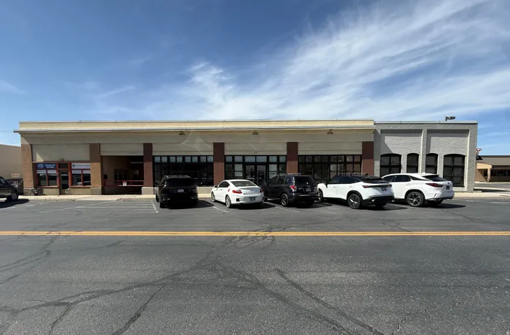 View of commercial property with uncovered parking