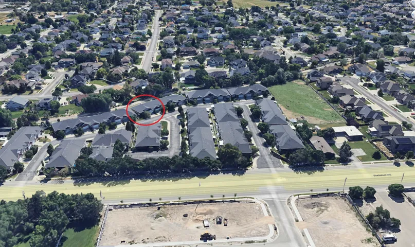 Aerial view of property and surrounding area with nearby suburban area