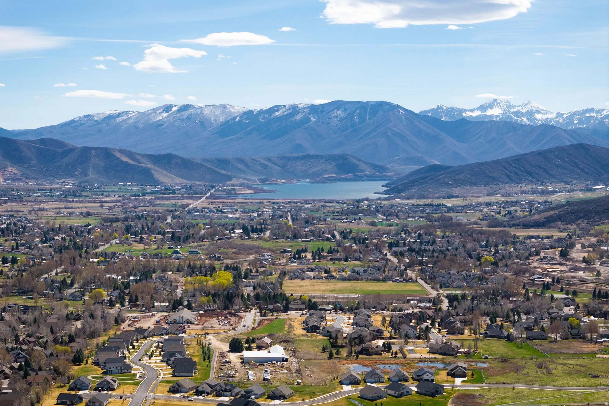 View of mountain background featuring nearby suburban area and a large body of water