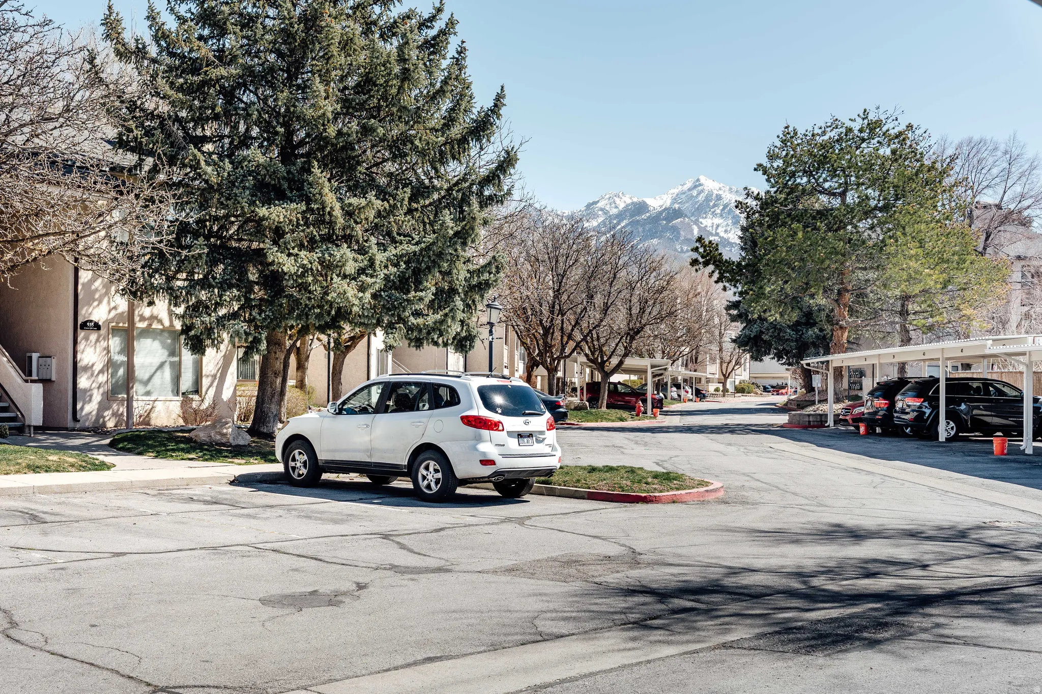 View of asphalt road featuring curbs and a mountain view