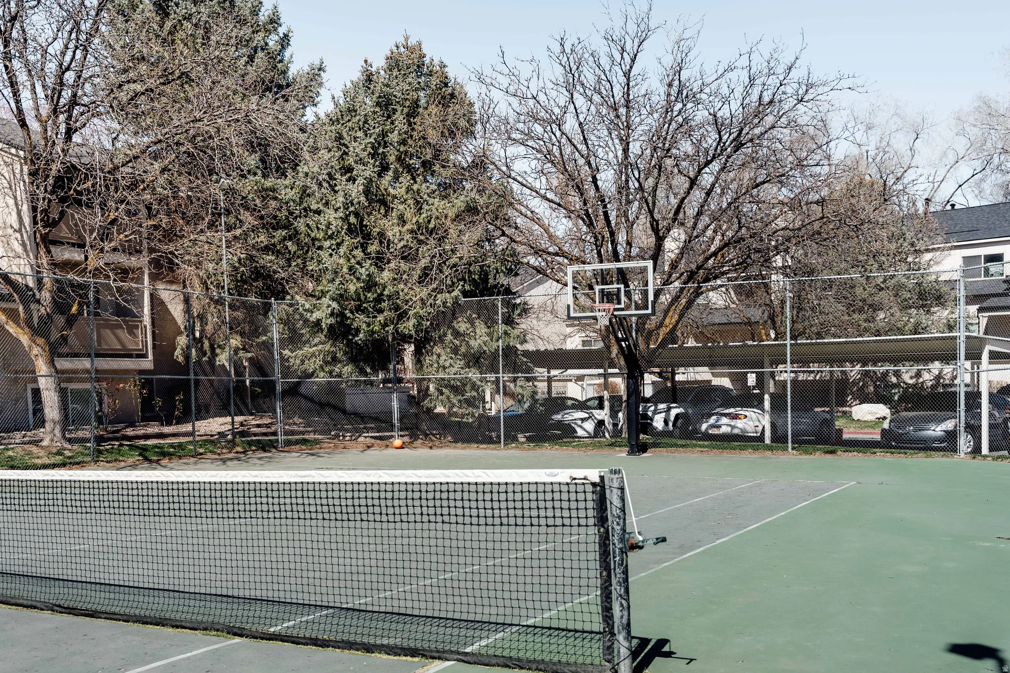 View of tennis court featuring community basketball court
