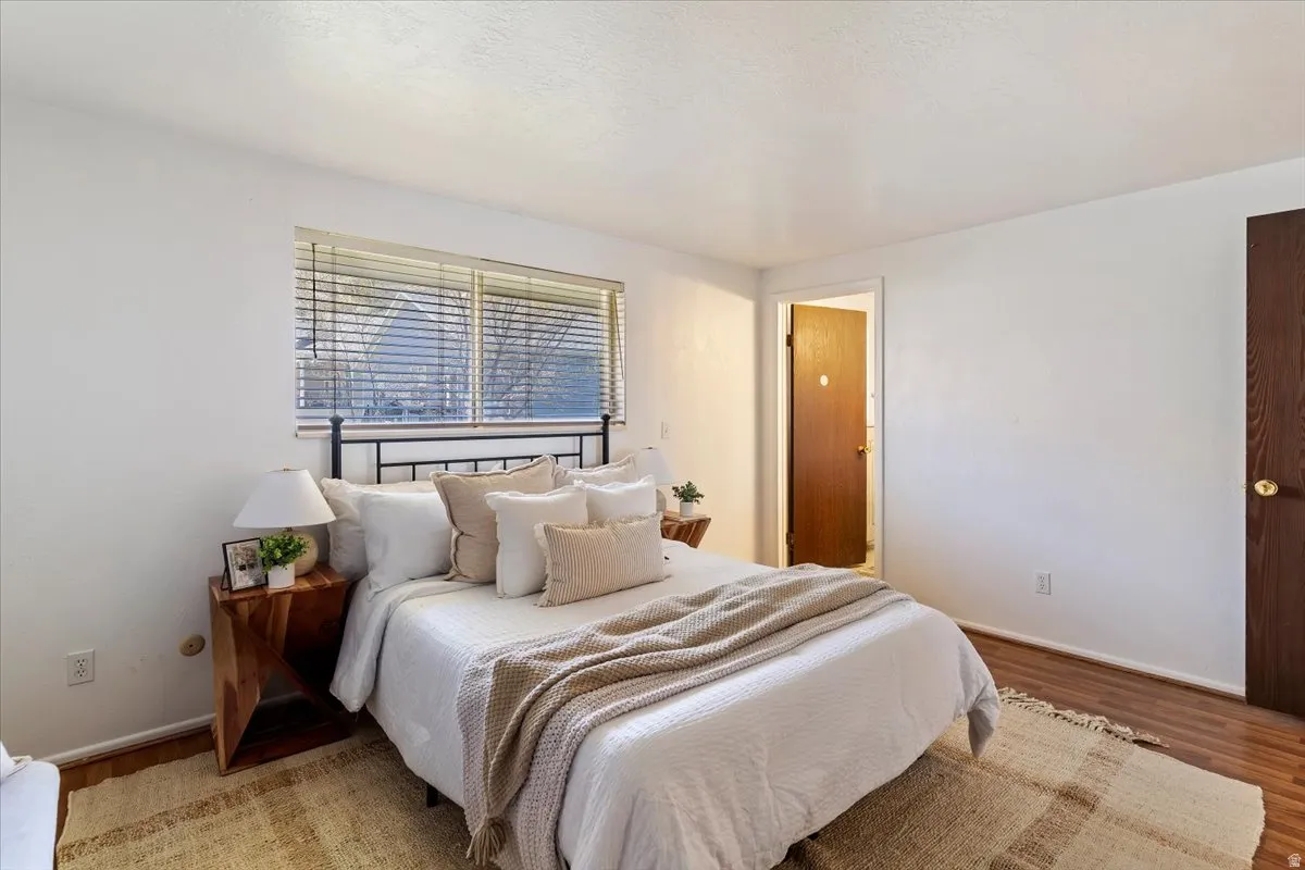 Bedroom with baseboards and wood finished floors