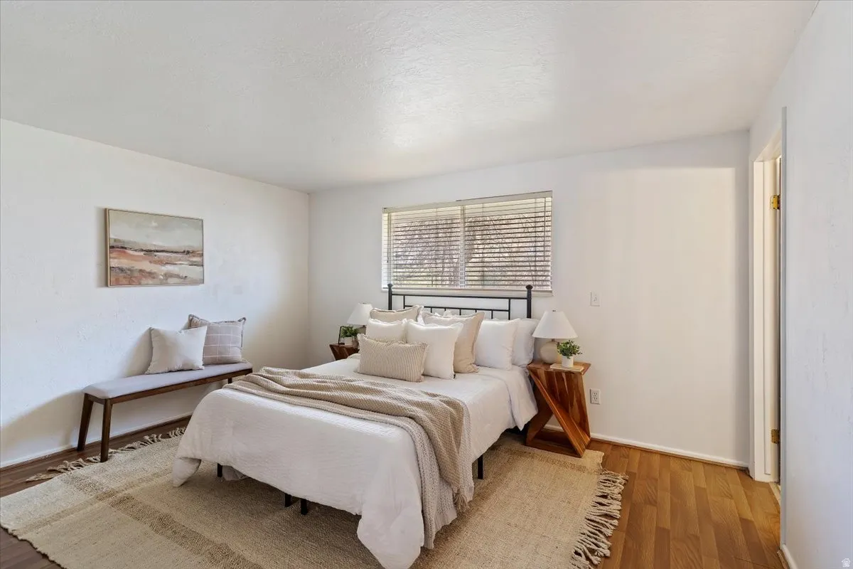 Bedroom featuring wood finished floors and baseboards