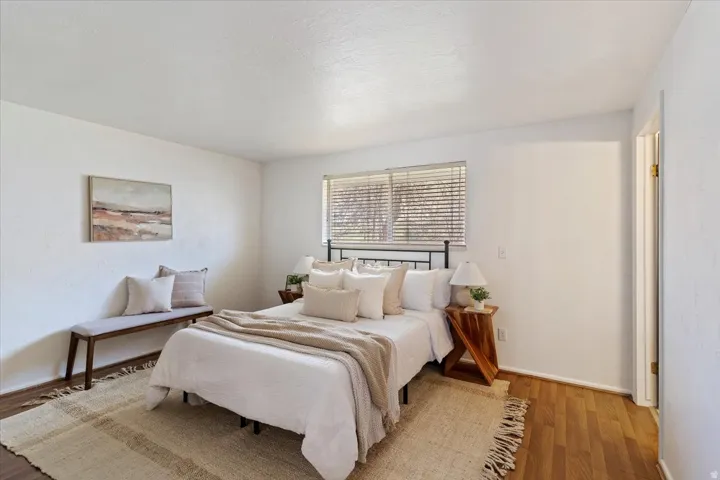 Bedroom featuring wood finished floors and baseboards