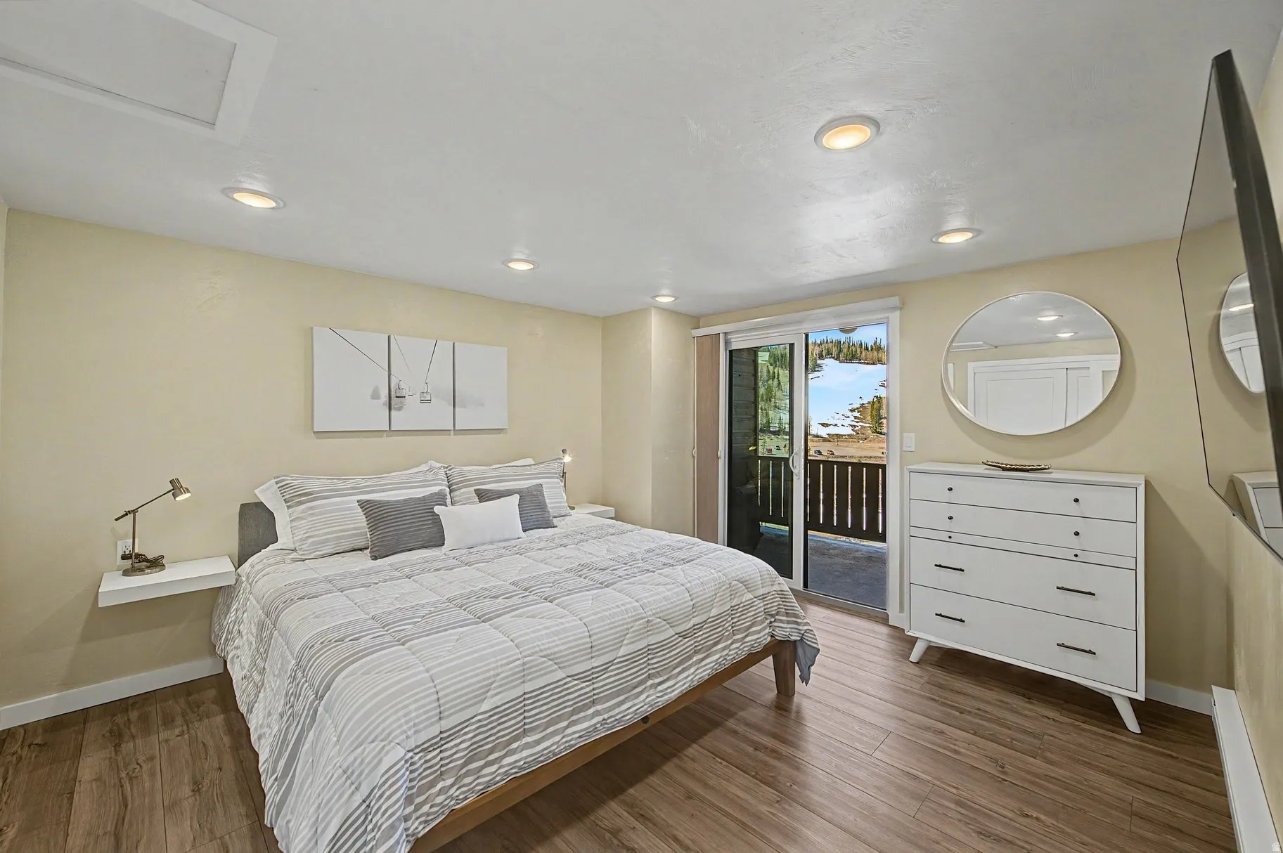 Bedroom with dark wood-type flooring, access to exterior, and recessed lighting