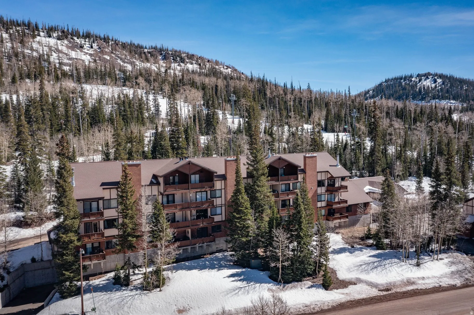 Snow covered building with a mountain view