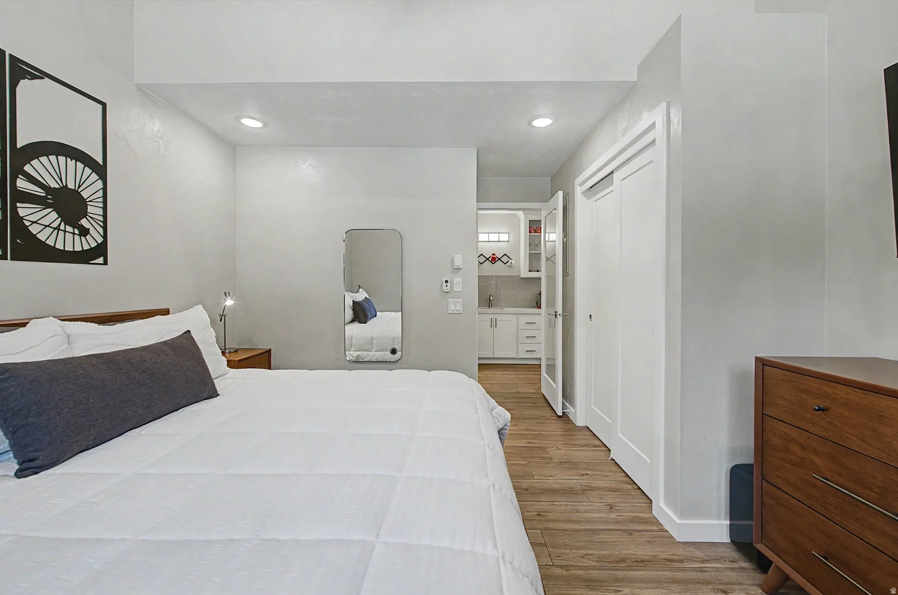Bedroom with light wood-style floors, a closet, and recessed lighting