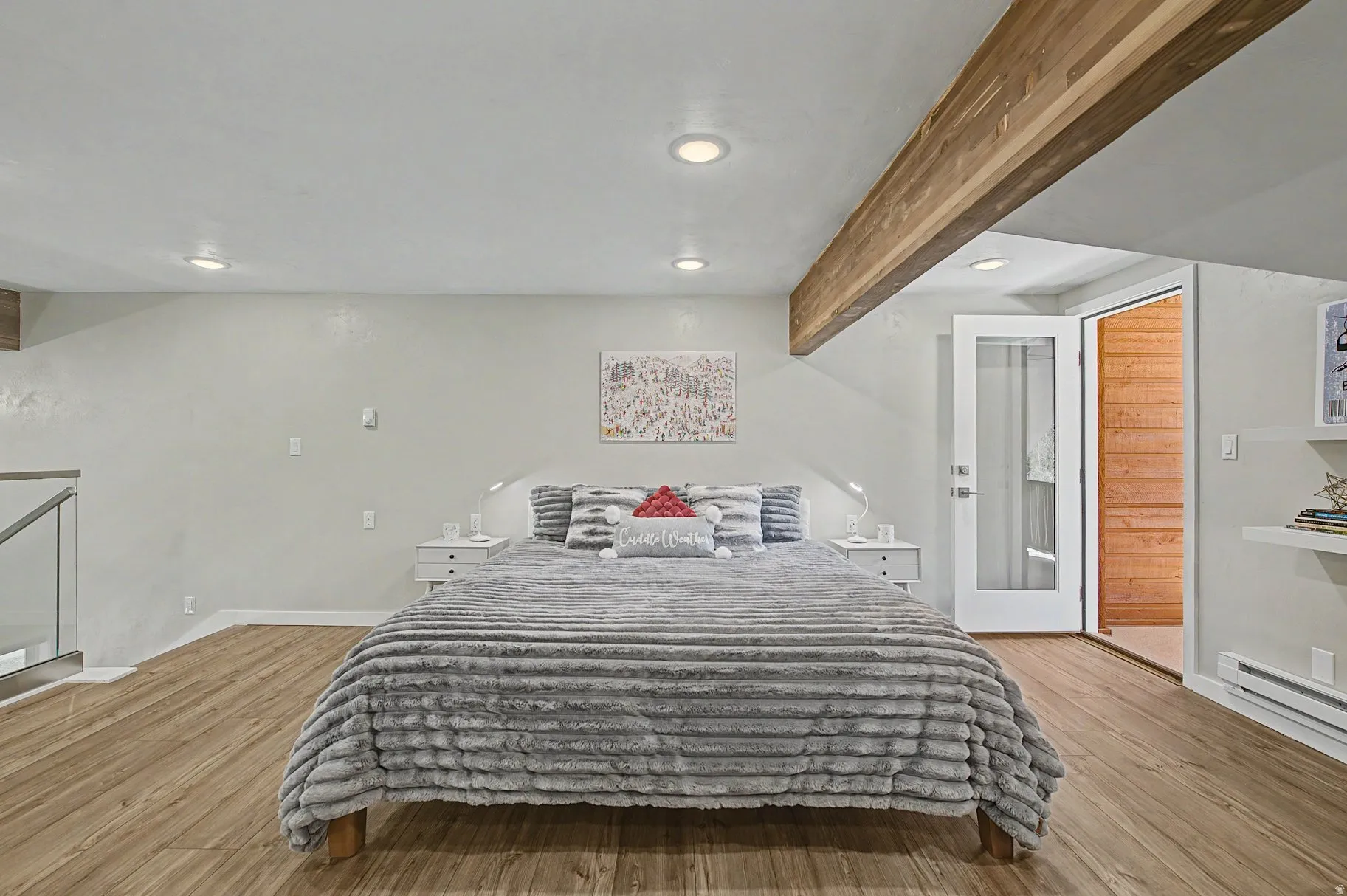 Bedroom with light wood finished floors, recessed lighting, and beam ceiling