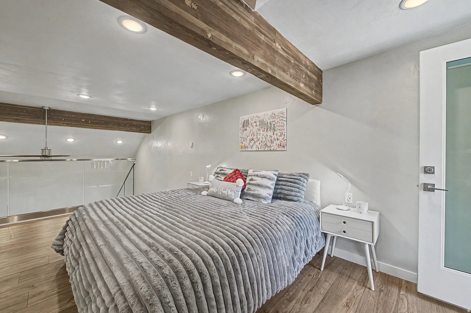 Bedroom with beam ceiling, recessed lighting, and light wood finished floors