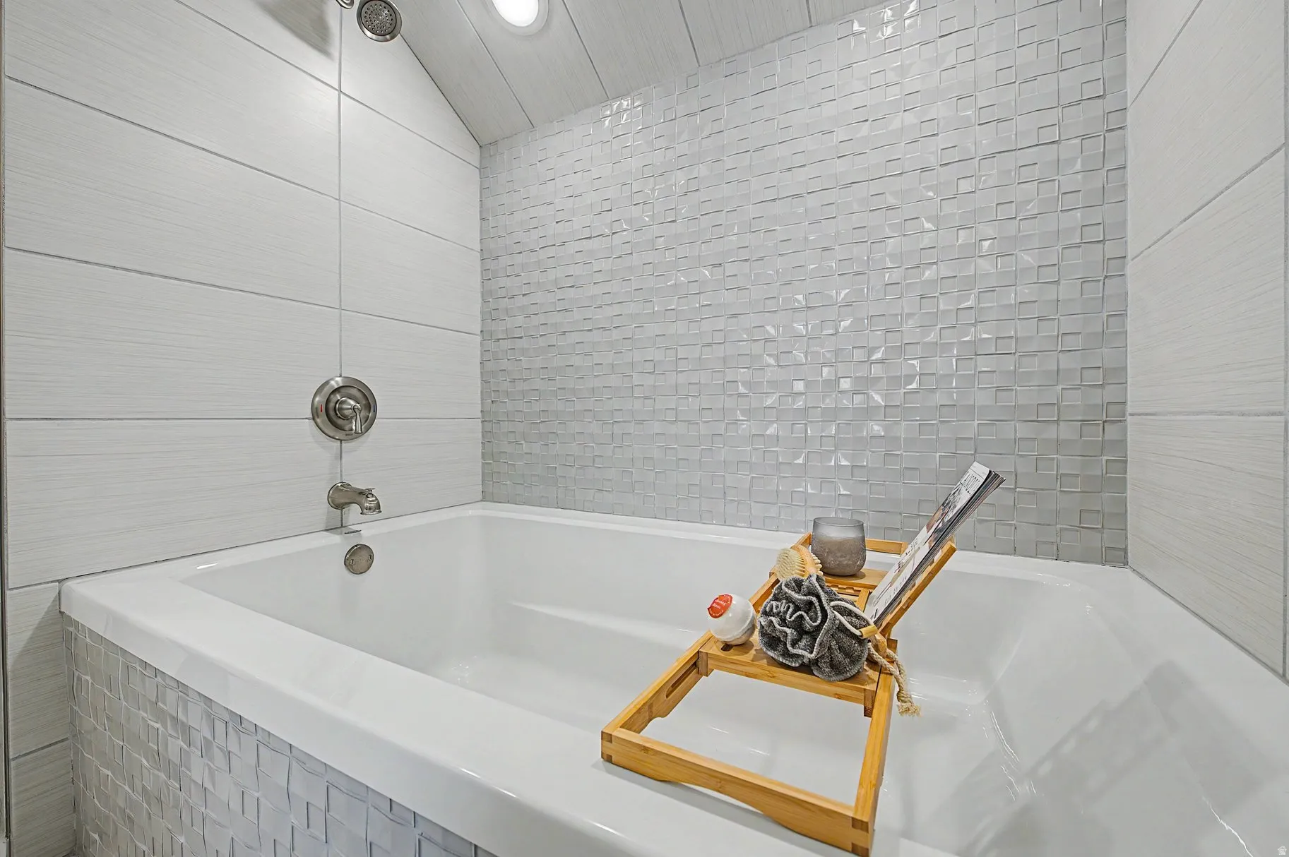 Bathroom featuring a bath and tile walls