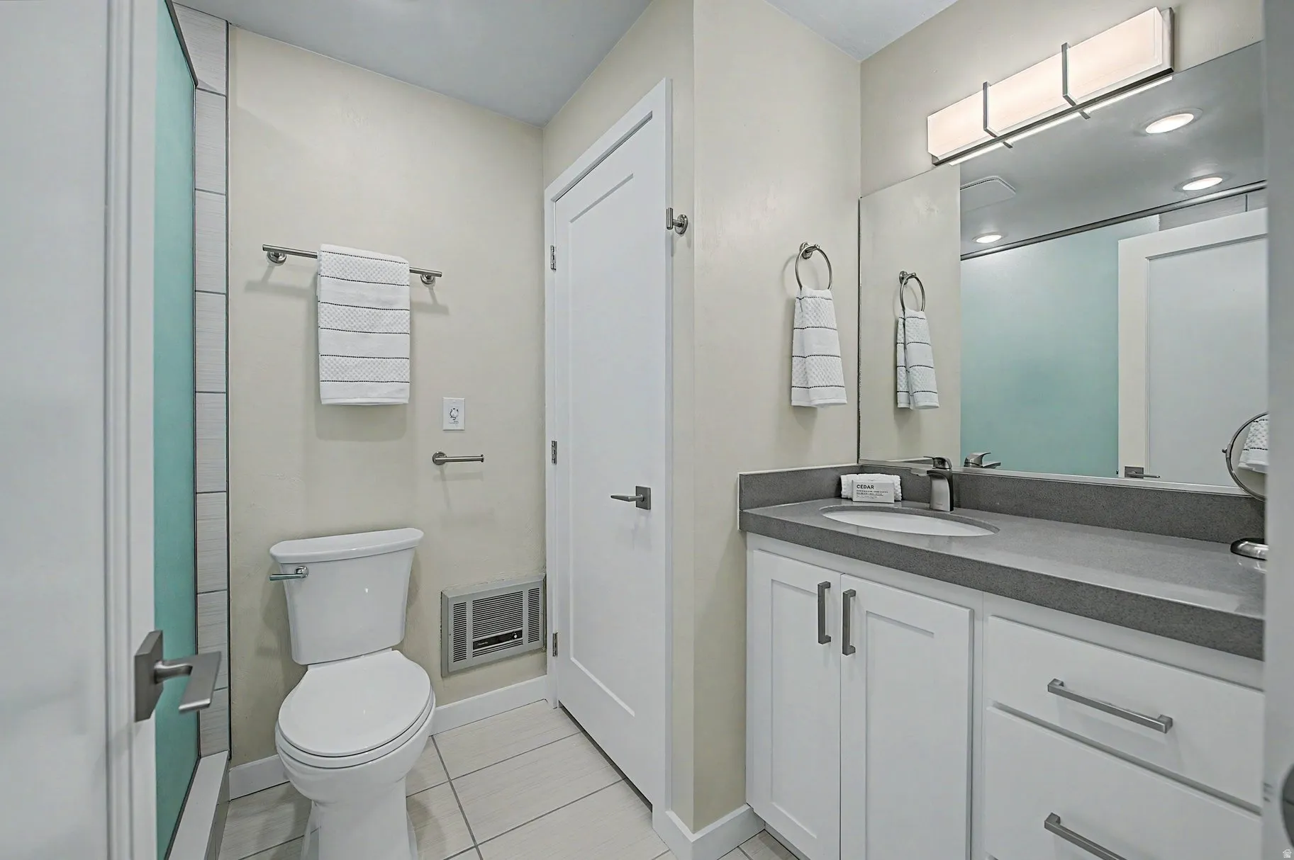 Full bathroom featuring vanity and light tile patterned flooring