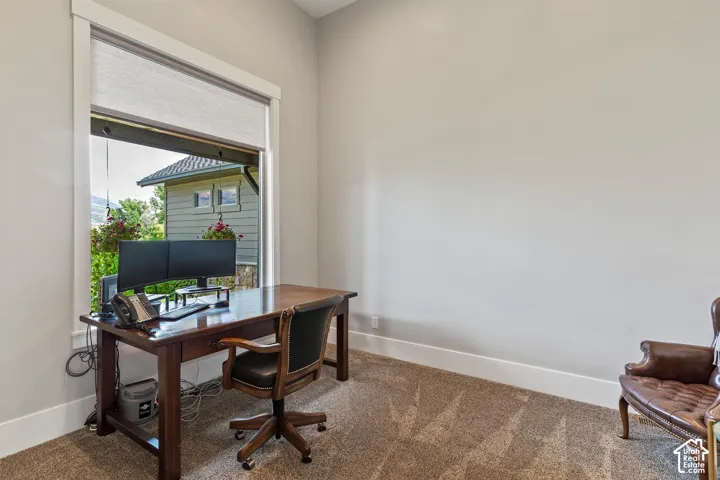 Carpeted home office near the entrance.