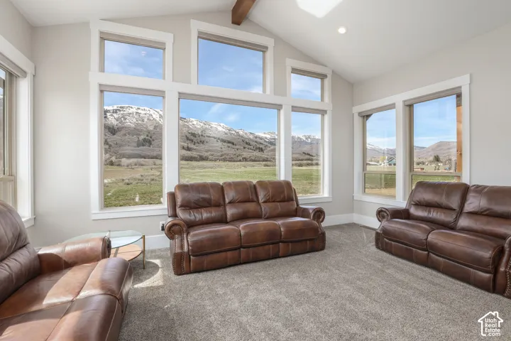 Carpeted living area featuring a mountain view, healthy amount of natural light, and recessed lighting