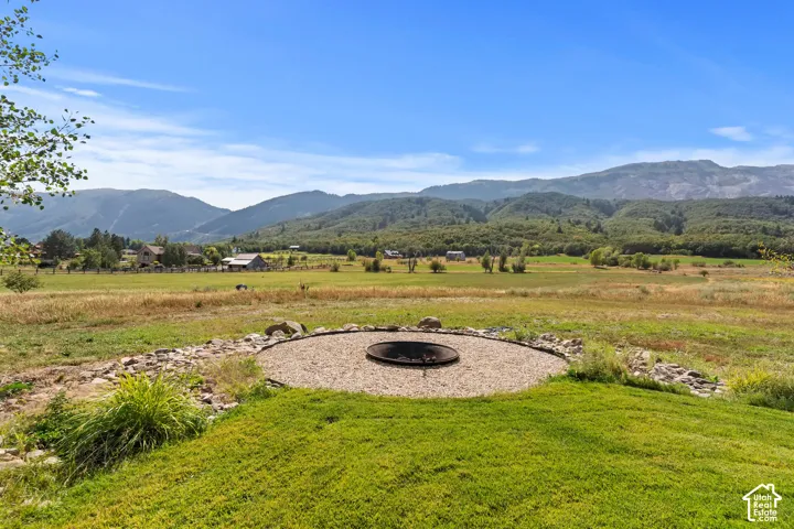 View of mountain background featuring fire pit.