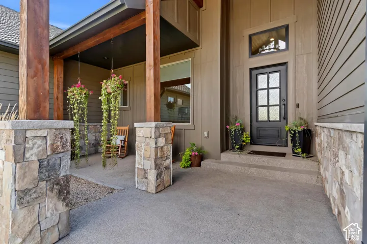 View of exterior entry featuring covered porch