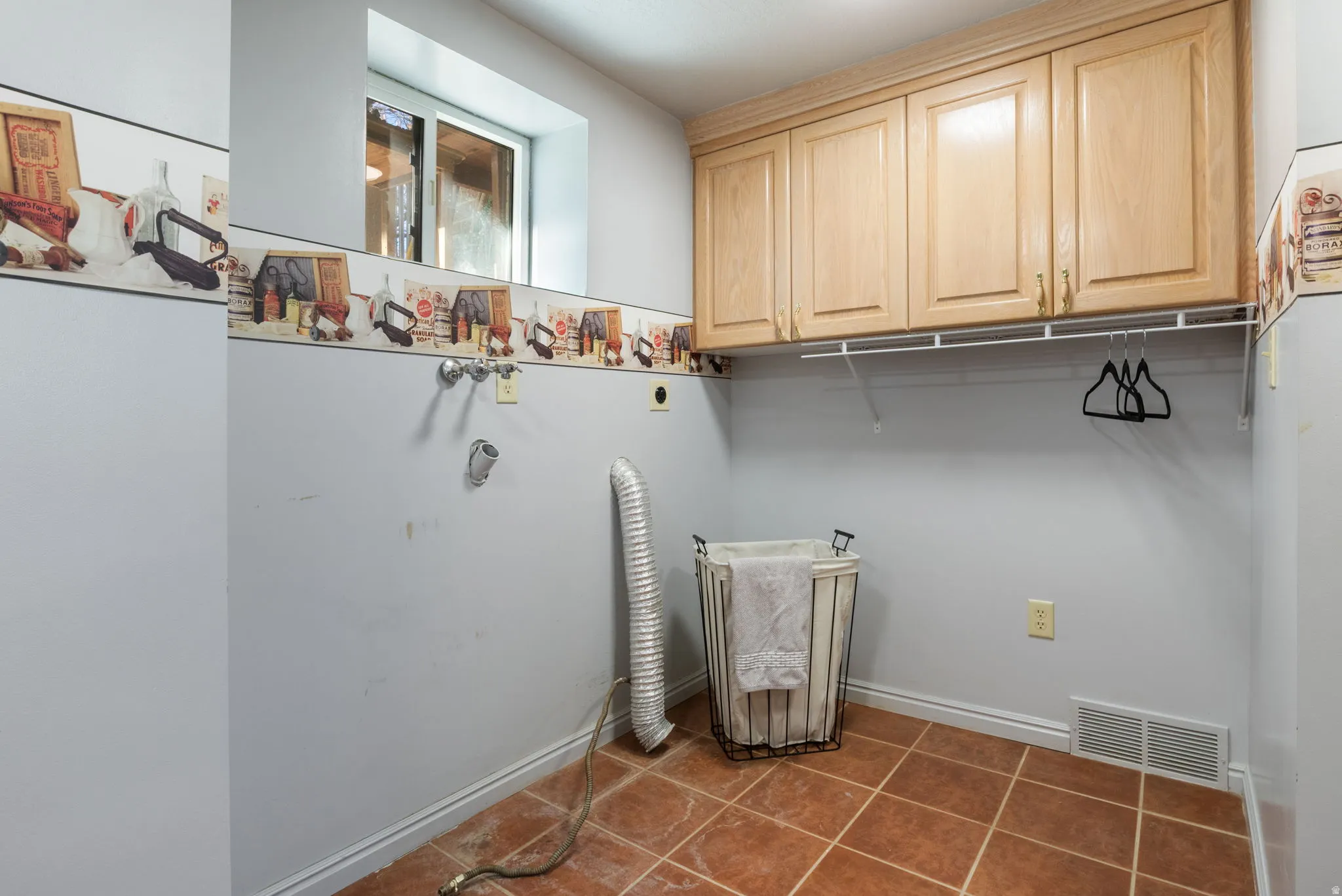 Laundry room with selves, tile, gas hook up for dryer.