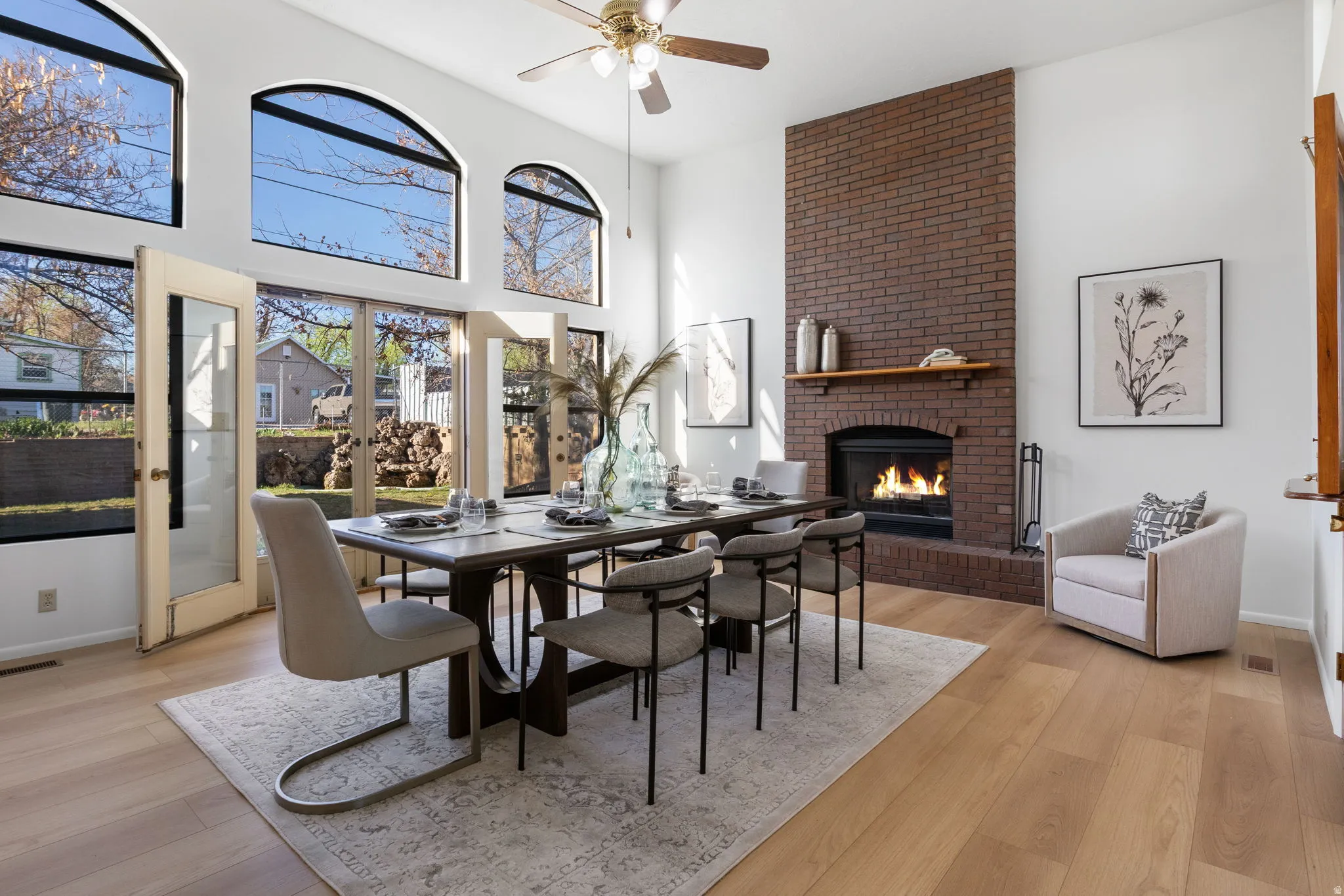 Dining area with vaulted ceiling, sitting area, fireplace, french doors to backyard, new LVP flooring.