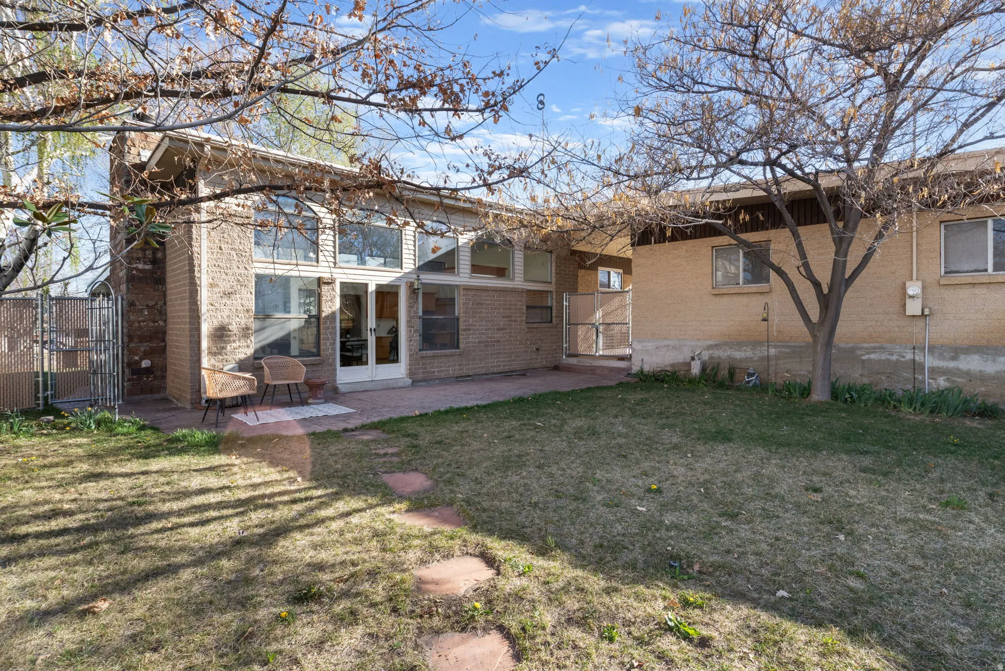Fully fenced backyard, stamped concrete patio and french doors for outdoor-indoor living.