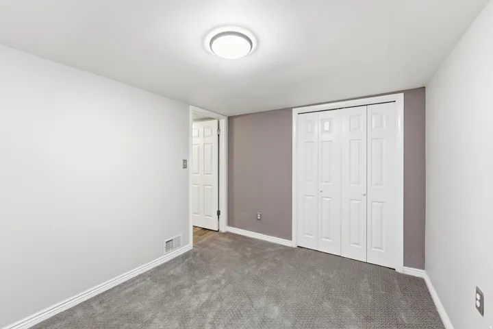Unfurnished bedroom featuring a closet and carpet