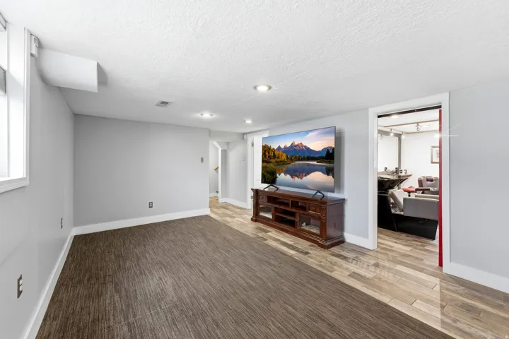 Living room with a textured ceiling and light wood finished floors