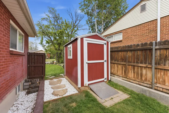 View of shed with a fenced backyard