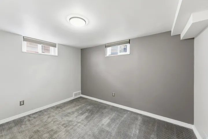 Basement featuring carpet floors and baseboards
