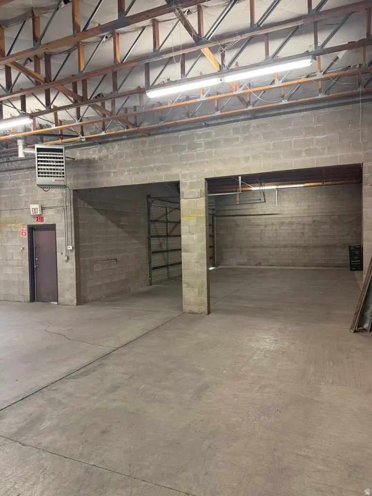 Parking deck featuring concrete block wall and a heating unit
