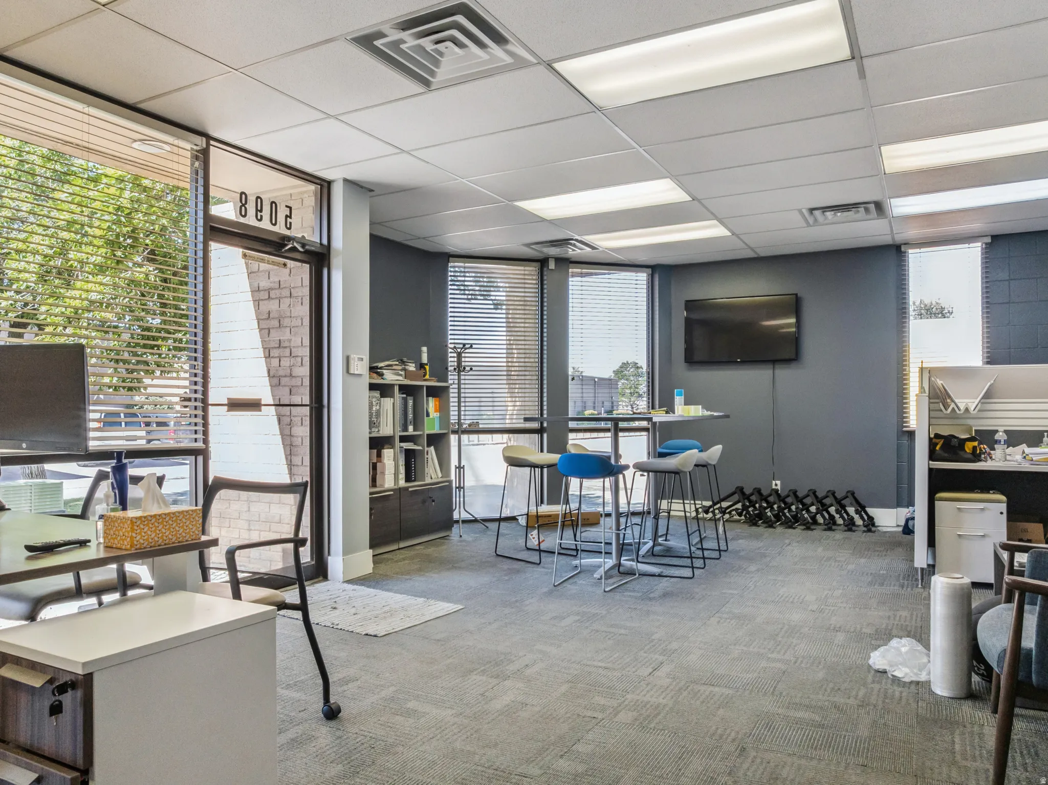 Office featuring a paneled ceiling and expansive windows