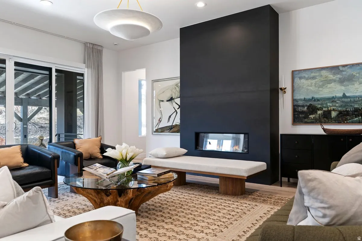 Living room featuring a multi sided fireplace, wood finished floors, and recessed lighting