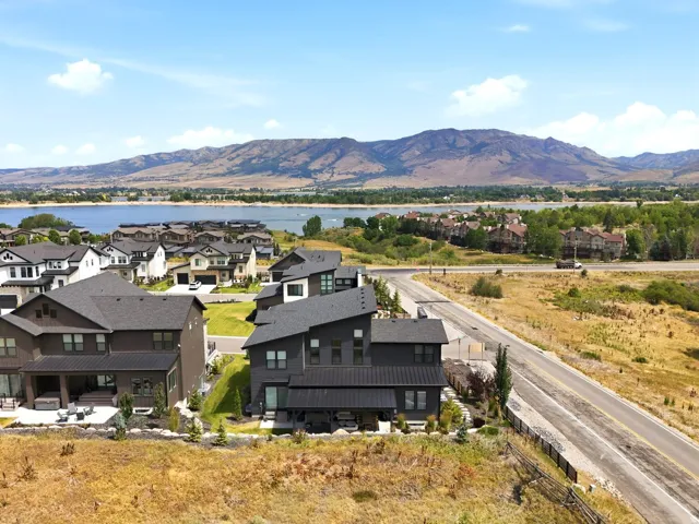 Modern home situated on an elevated lot with panoramic vistas of mountain ranges and distant waterfront