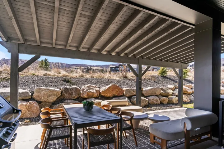View of patio with a grill, outdoor dining space, and a mountain view