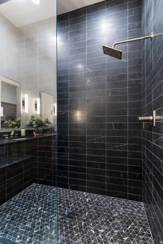 Bathroom featuring a shower stall and a sink