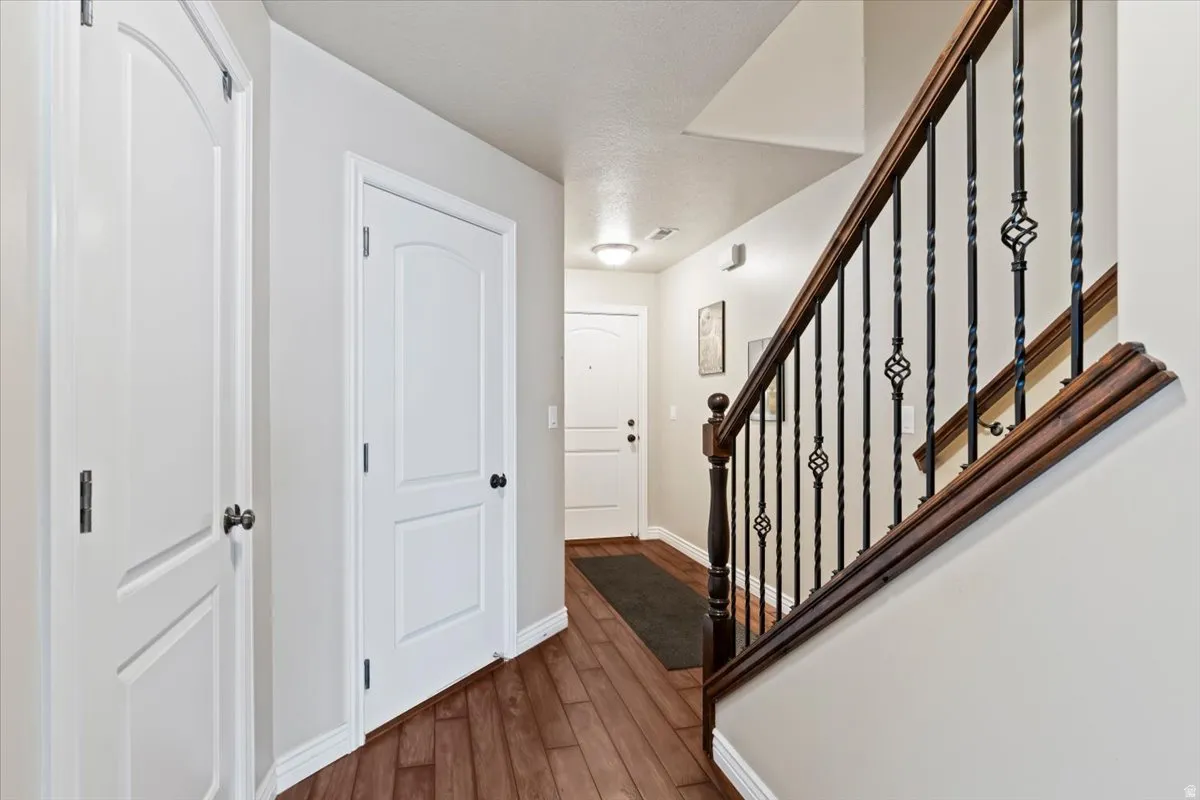 Entryway featuring stairs and dark wood finished floors