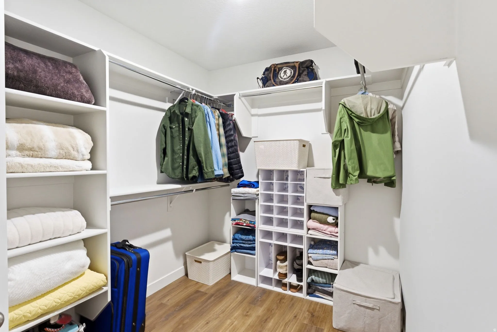 Walk in closet featuring light wood-style flooring