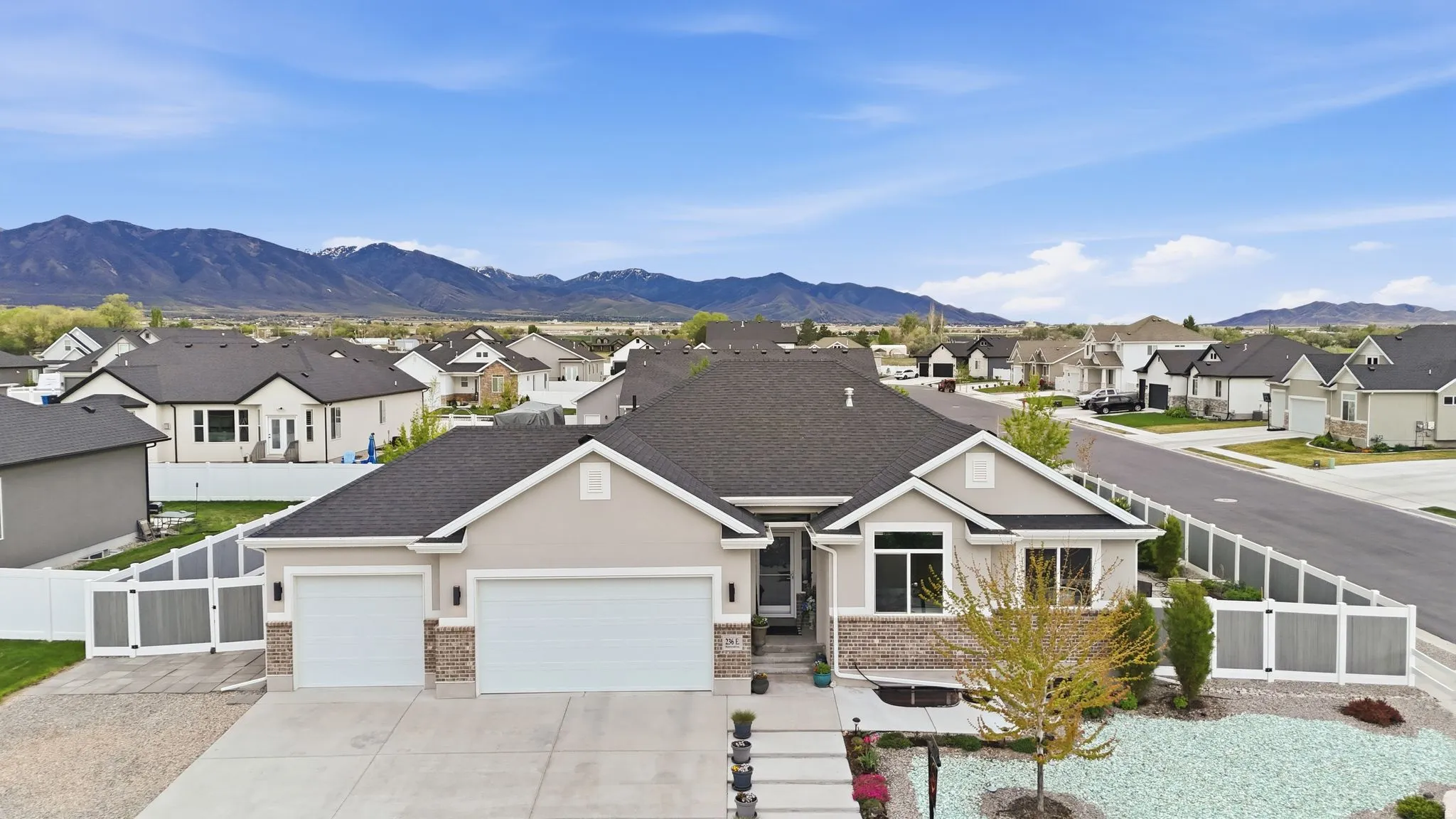 View of front of house with a residential view, an attached garage, a mountain view, and concrete driveway