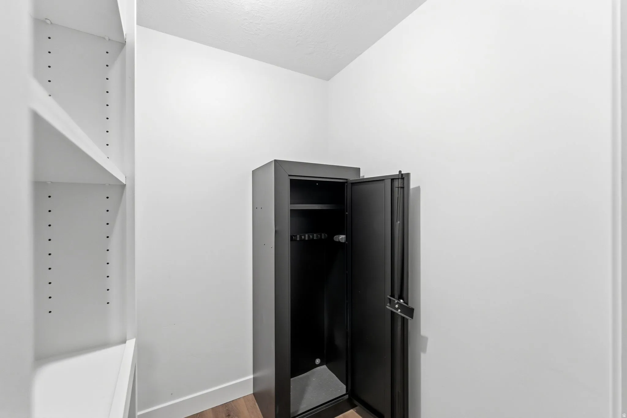Mudroom featuring light wood-style floors and baseboards