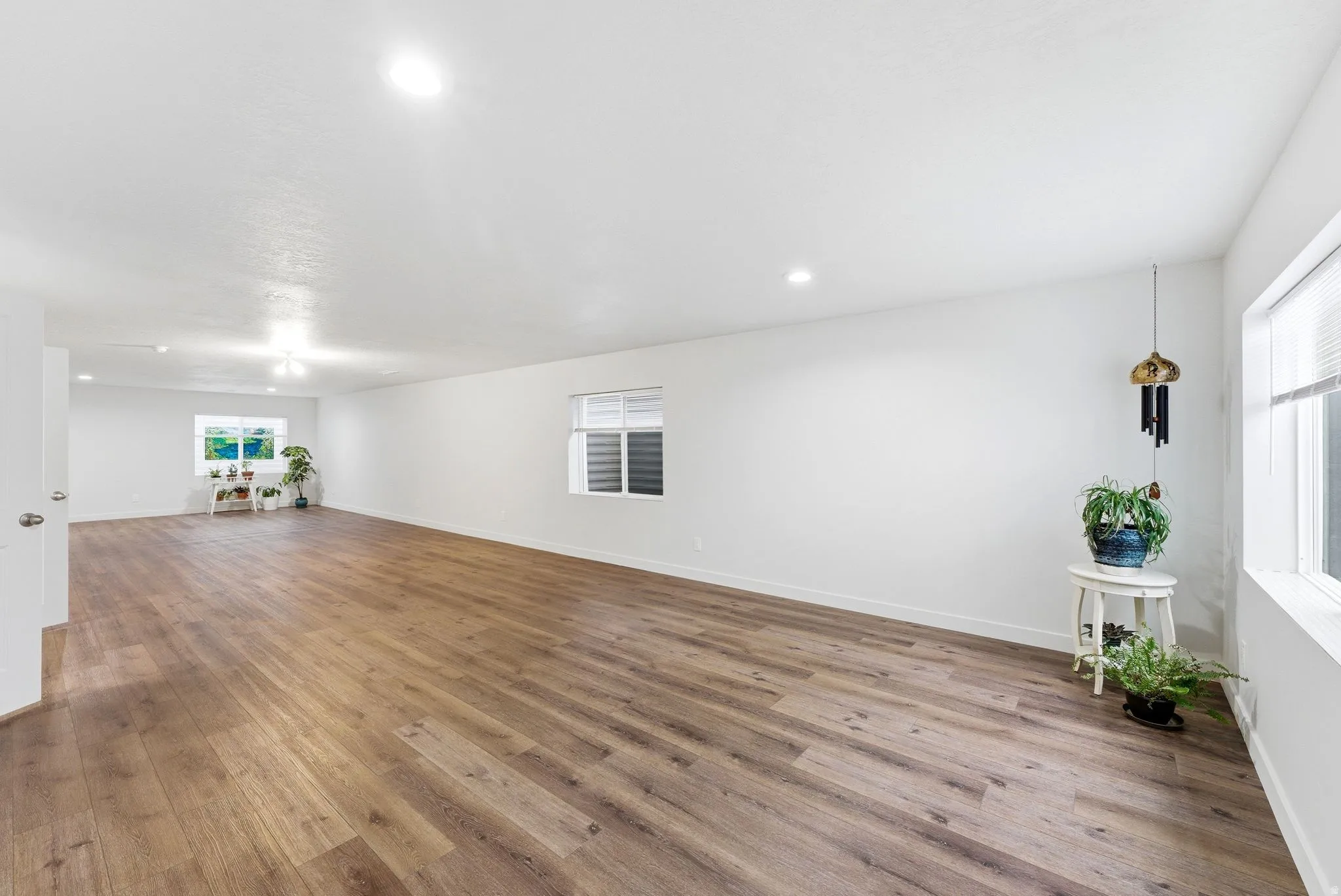 Empty room featuring light wood-style flooring and recessed lighting