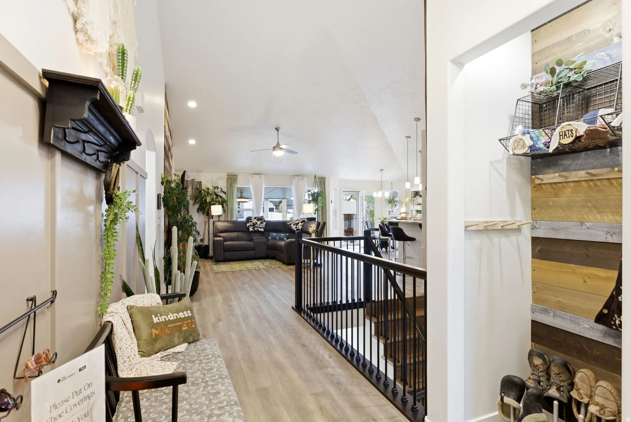 Corridor with light wood-style flooring, an upstairs landing, recessed lighting, and vaulted ceiling