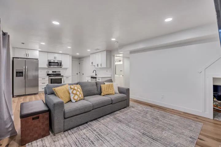 Living room with light wood-style floors and recessed lighting