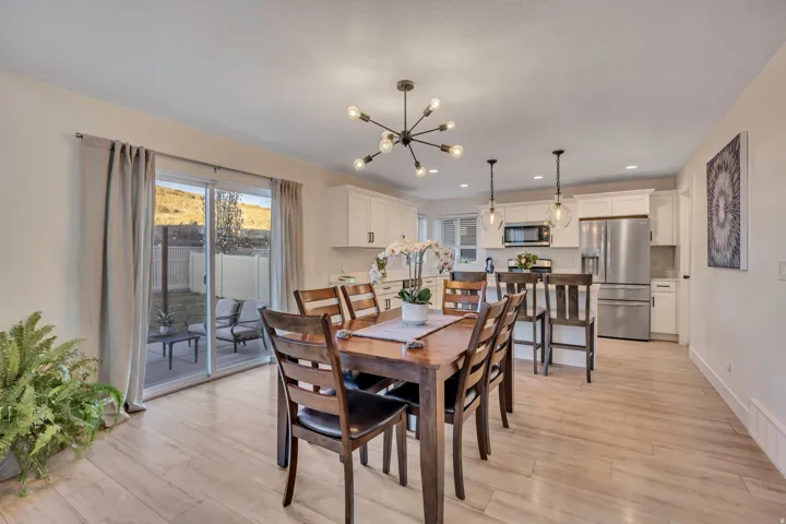 Dining space with light wood finished floors and a chandelier