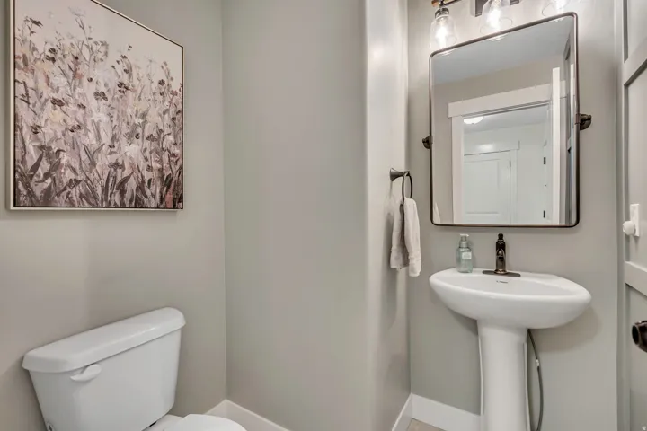 Half bath with toilet and baseboards
