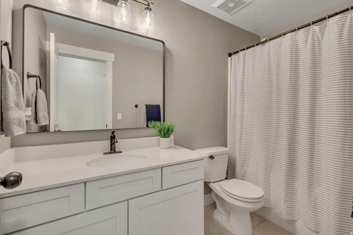 Full bathroom with vanity and light tile patterned flooring